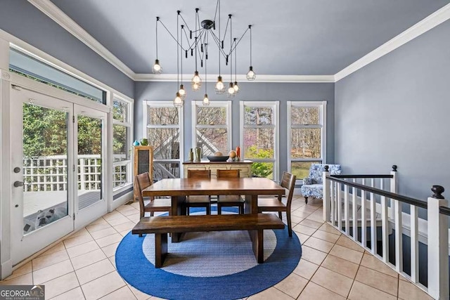 1768 Hood Rd, Dacula, GA 30019 - dining room with light tile patterned floors, a chandelier, healthy amount of natural light, and ornamental molding