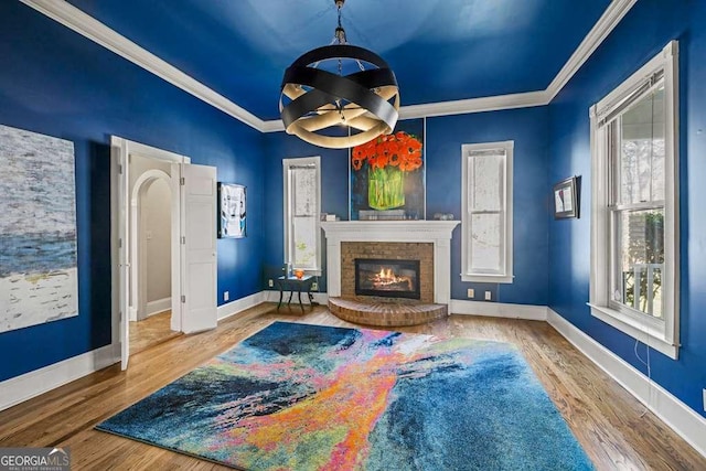 1768 Hood Rd, Dacula, GA 30019 - living area featuring crown molding, baseboards, a fireplace, and wood finished floors