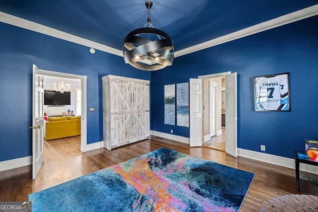 1768 Hood Rd, Dacula, GA 30019 - bedroom featuring a chandelier, crown molding, baseboards, and wood finished floors