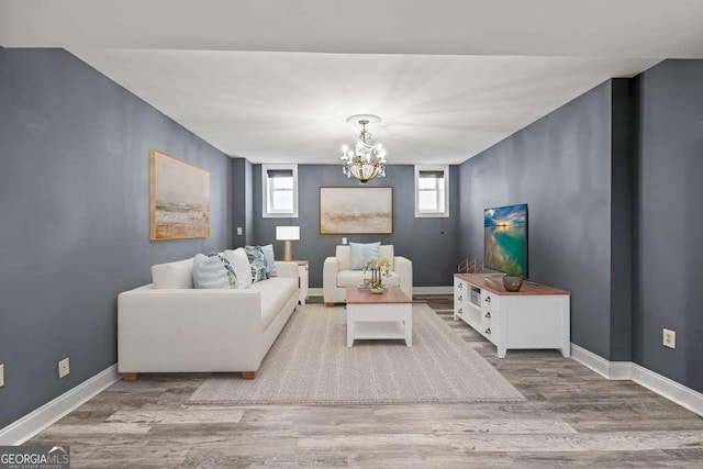 1768 Hood Rd, Dacula, GA 30019 - living area with a chandelier, healthy amount of natural light, wood finished floors, and baseboards
