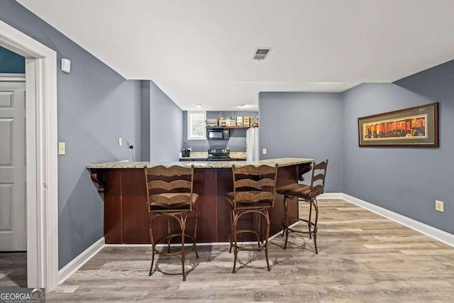 1768 Hood Rd, Dacula, GA 30019 - indoor wet bar featuring black appliances, wood finished floors, and baseboards