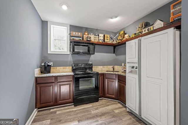1768 Hood Rd, Dacula, GA 30019 - kitchen with black appliances, a sink, light wood finished floors, and light stone counters
