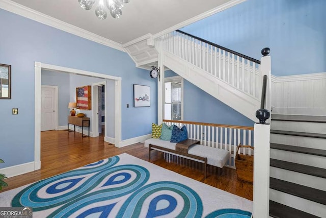 1768 Hood Rd, Dacula, GA 30019 - living area with crown molding, stairs, wood finished floors, and baseboards