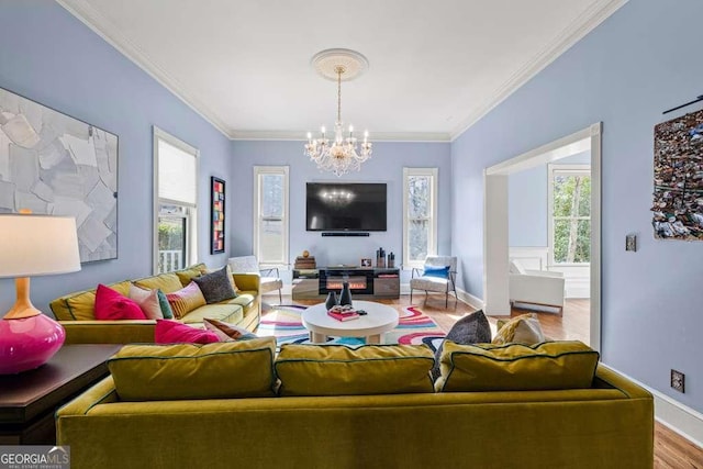 1768 Hood Rd, Dacula, GA 30019 - living room with a chandelier, wood finished floors, ornamental molding, and baseboards