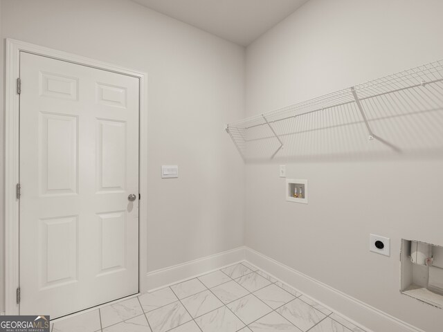 clothes washing area with hookup for a washing machine, baseboards, marble finish floor, laundry area, and electric dryer hookup