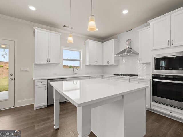 kitchen with visible vents, ornamental molding, appliances with stainless steel finishes, dark wood-type flooring, and wall chimney range hood