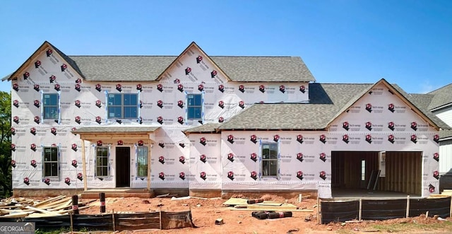 property under construction with roof with shingles