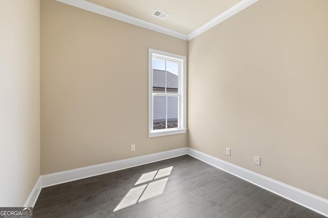 empty room featuring baseboards, visible vents, ornamental molding, and dark wood-style flooring