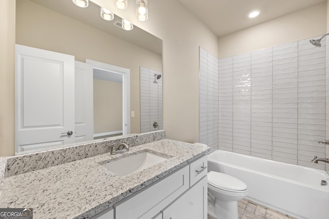 bathroom featuring toilet, vanity, and shower / bathtub combination