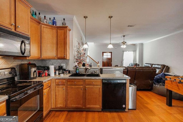 264 Center Park Ln, Athens, GA 30605 - kitchen with open floor plan, a sink, a peninsula, black appliances, and brown cabinets