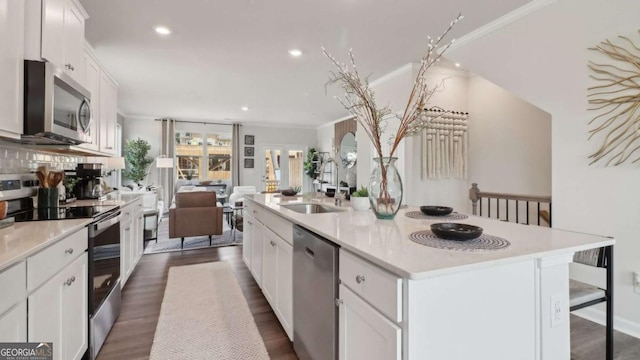kitchen with white cabinetry, a sink, stainless steel appliances, and dark wood finished floors