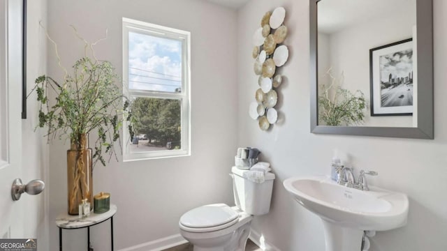 bathroom with toilet and a sink