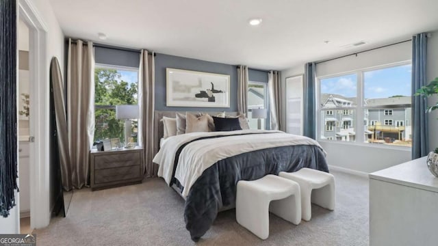 bedroom featuring light carpet, baseboards, and visible vents