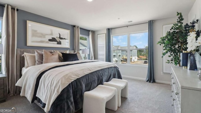 bedroom with light carpet, baseboards, and visible vents