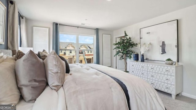 bedroom with baseboards and carpet