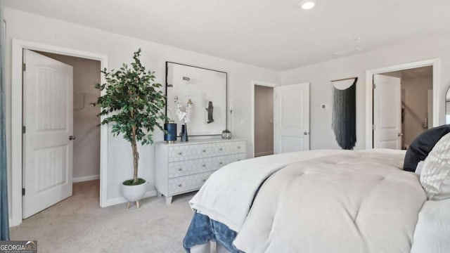 bedroom featuring baseboards and light colored carpet