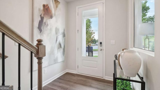 entrance foyer with baseboards, stairway, and dark wood finished floors