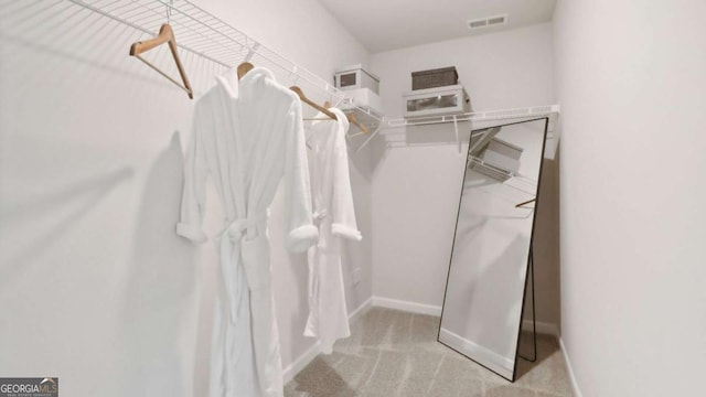 spacious closet featuring visible vents and carpet