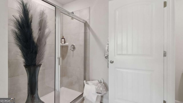 full bath with a shower stall