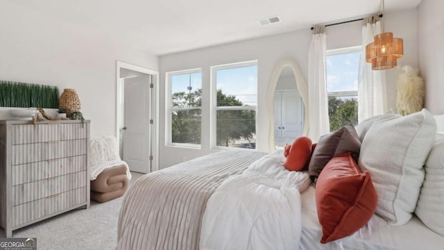 carpeted bedroom with visible vents