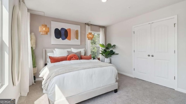 bedroom with baseboards, a closet, and carpet floors