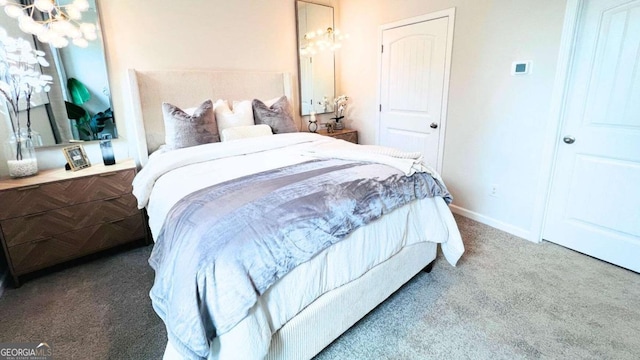 bedroom featuring baseboards, a notable chandelier, and carpet floors