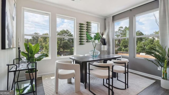 dining area featuring baseboards and wood finished floors