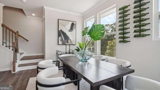 interior space with ornamental molding, baseboards, and wood finished floors