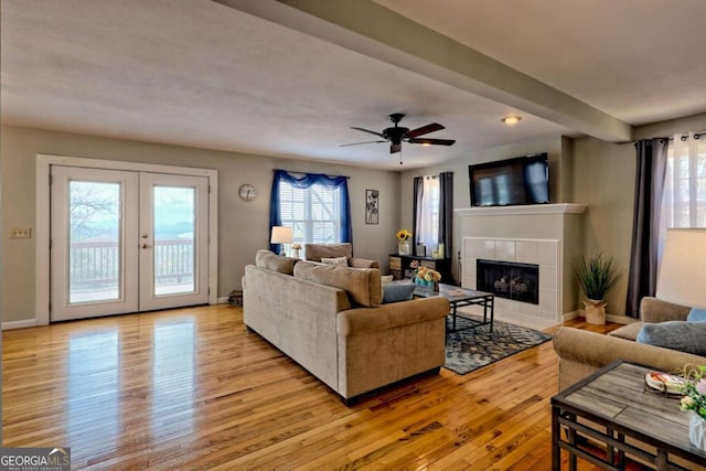 417 Hidden Forest Ln, Hayesville, NC 28904 - living area featuring light wood-type flooring, a tiled fireplace, french doors, and ceiling fan