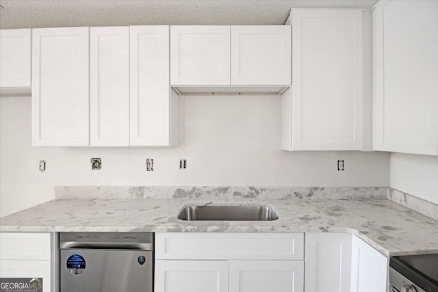 kitchen featuring dishwasher, white cabinetry, a sink, and light stone counters
