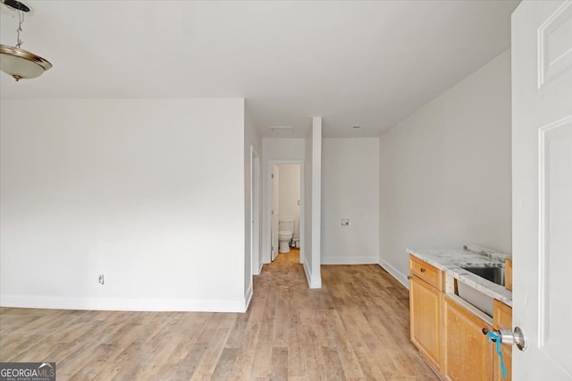 interior space featuring light wood-style floors and baseboards