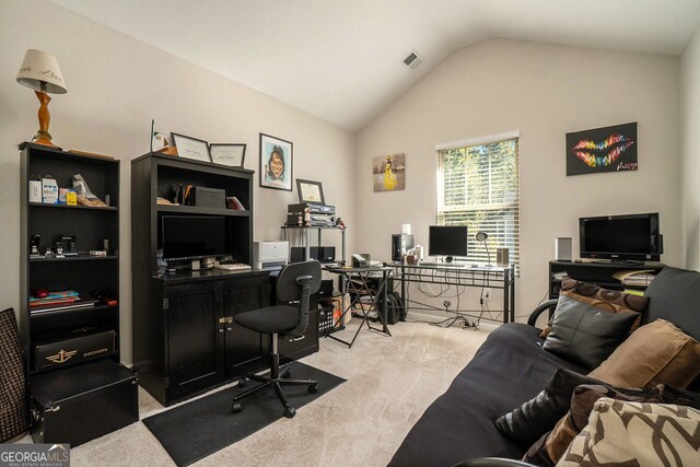 office space with visible vents, light colored carpet, and lofted ceiling