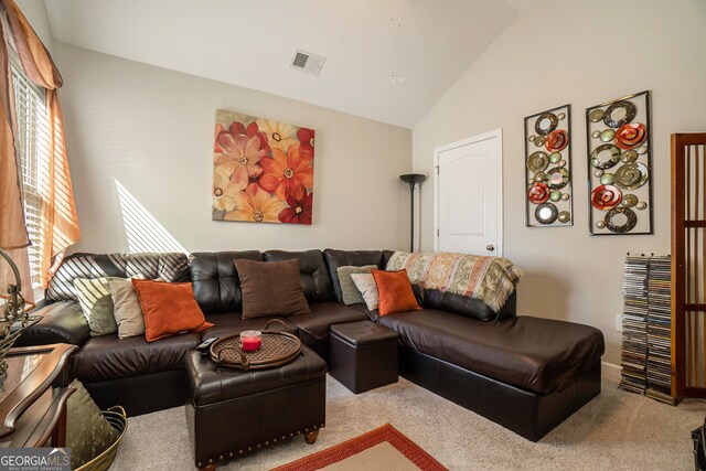 living room featuring carpet flooring, high vaulted ceiling, and visible vents