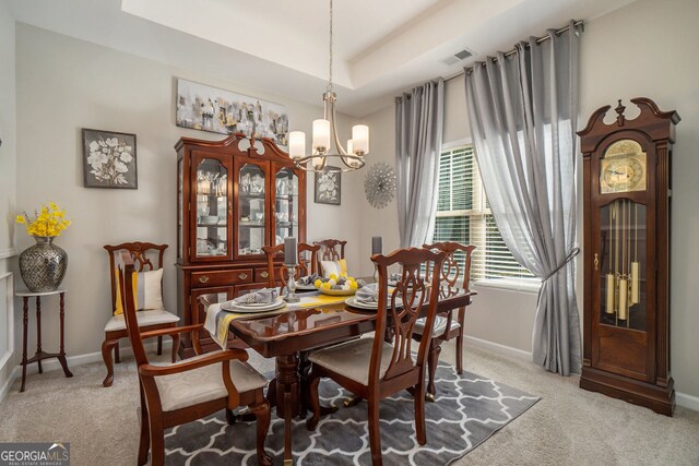 dining area featuring visible vents, baseboards, a chandelier, and carpet