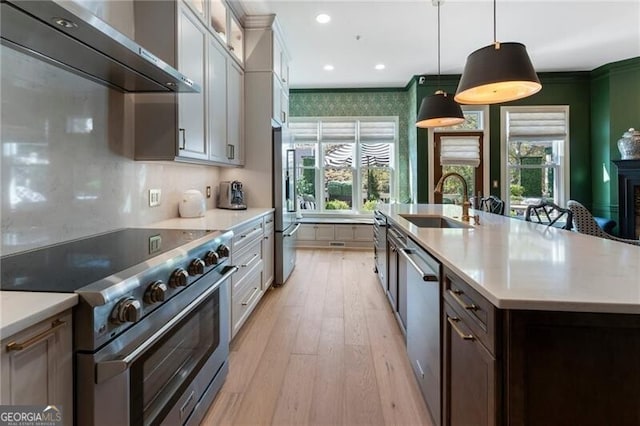 2630 Milford Ln, Alpharetta, GA 30009 - kitchen with stainless steel appliances, wall chimney range hood, plenty of natural light, light countertops, and crown molding