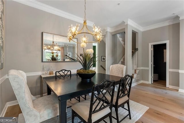 2630 Milford Ln, Alpharetta, GA 30009 - dining area with stairway, light wood-style floors, a chandelier, and crown molding