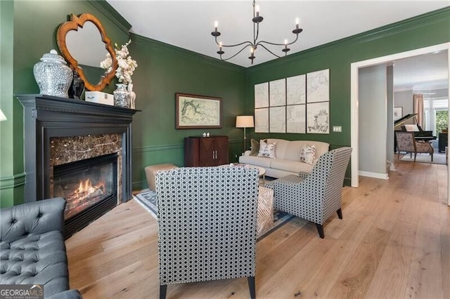 2630 Milford Ln, Alpharetta, GA 30009 - living area featuring wood finished floors, a chandelier, ornamental molding, and a fireplace