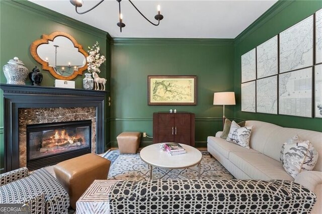 2630 Milford Ln, Alpharetta, GA 30009 - living area with ornamental molding, a chandelier, and a fireplace