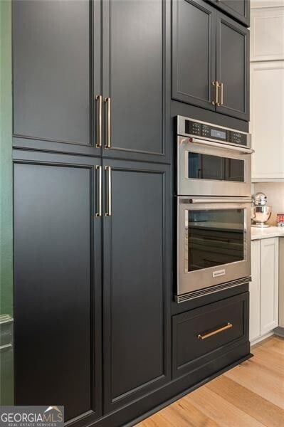 2630 Milford Ln, Alpharetta, GA 30009 - kitchen with double oven, light wood-style flooring, and light countertops