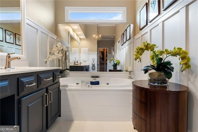2630 Milford Ln, Alpharetta, GA 30009 - bathroom featuring a high ceiling, a chandelier, vanity, a whirlpool tub, and tile patterned flooring