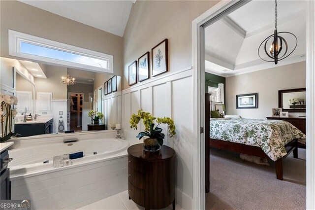 2630 Milford Ln, Alpharetta, GA 30009 - ensuite bathroom featuring a chandelier, vanity, lofted ceiling, a jetted tub, and a decorative wall