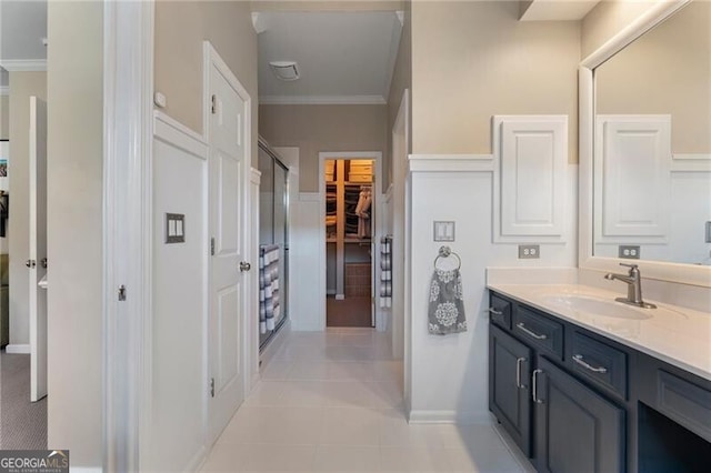 2630 Milford Ln, Alpharetta, GA 30009 - full bathroom with vanity, a stall shower, crown molding, a spacious closet, and tile patterned flooring