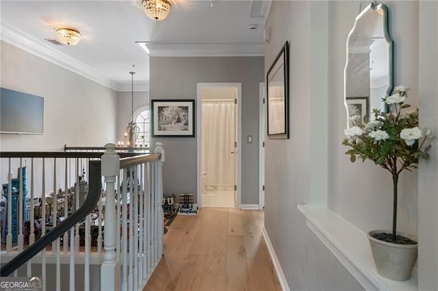 2630 Milford Ln, Alpharetta, GA 30009 - corridor with light wood finished floors, an upstairs landing, ornamental molding, and a chandelier