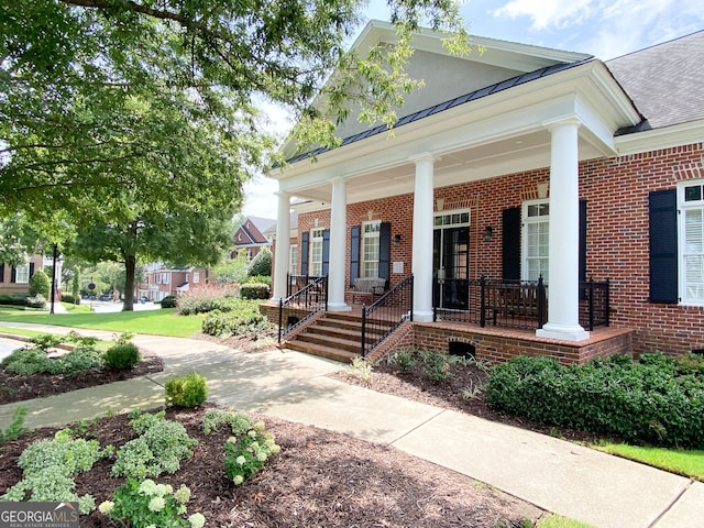 2630 Milford Ln, Alpharetta, GA 30009 - view of front facade featuring brick siding, a porch, a standing seam roof, and a shingled roof