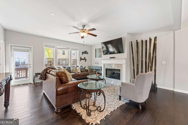 2699 Village Park Bnd, Duluth, GA 30096 - living area featuring a premium fireplace, a ceiling fan, and dark wood finished floors