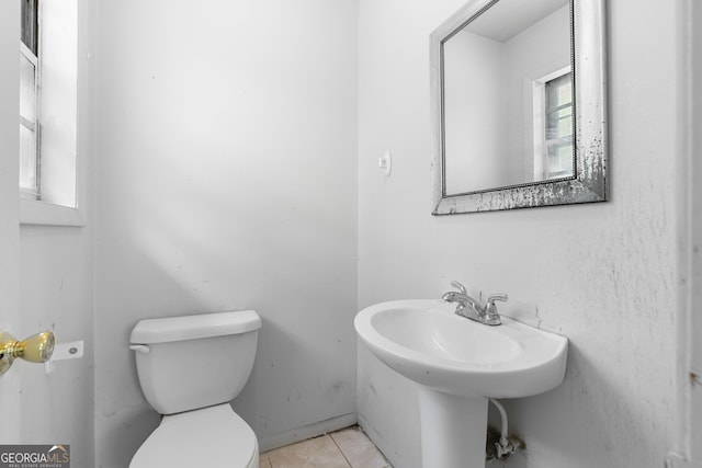 bathroom with toilet and tile patterned flooring
