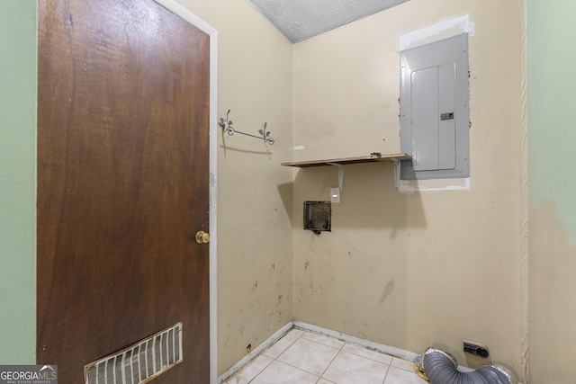 laundry area with visible vents, light tile patterned floors, baseboards, electric panel, and laundry area