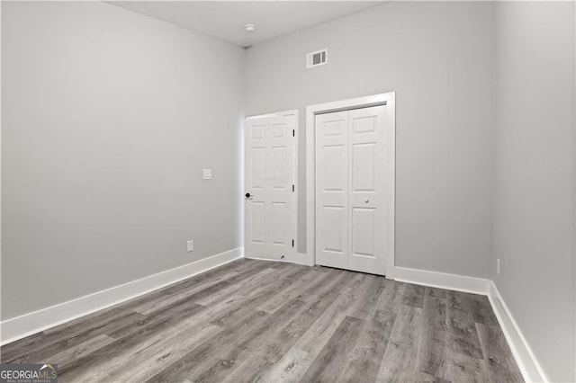358 Roy St SW, Atlanta, GA 30310 - unfurnished bedroom featuring baseboards, wood finished floors, and a closet