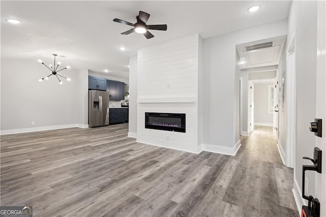 358 Roy St SW, Atlanta, GA 30310 - unfurnished living room with attic access, wood finished floors, baseboards, a glass covered fireplace, and ceiling fan