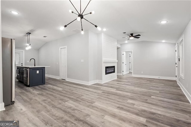 358 Roy St SW, Atlanta, GA 30310 - unfurnished living room with lofted ceiling, wood finished floors, ceiling fan, a large fireplace, and baseboards